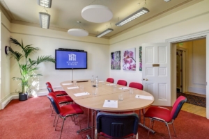 Inside the Hanbury Suite with a table set up for a corporate meeting.