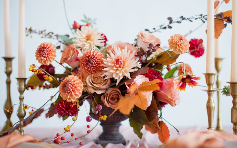 Hylands event feat web An autumnal wedding centrepiece surrounded by taper candles.
