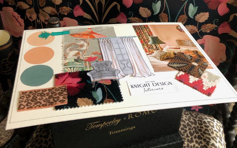 Fabric swatches and paint samples with Knight Design Interior's logo.