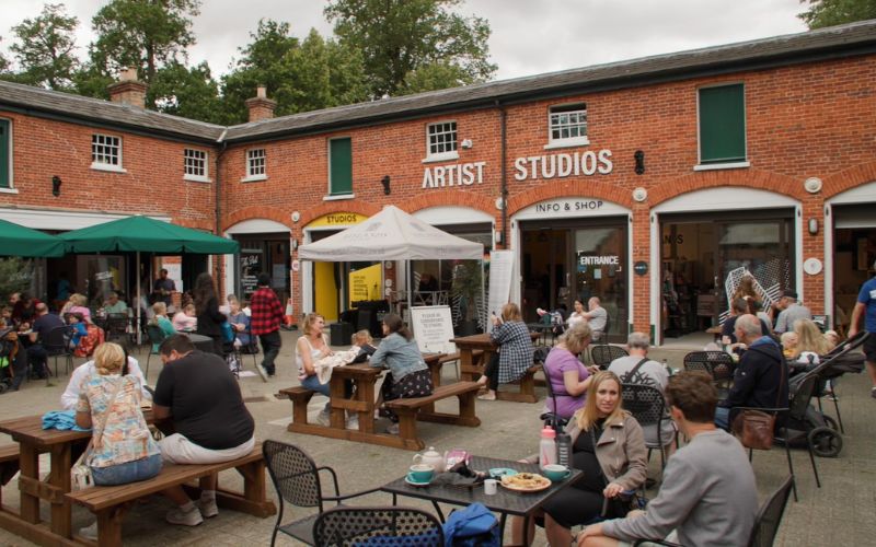 People enjoying the courtyard area of The Stables.