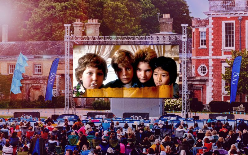 AC Goonies The Goonies showing on a large outdoor screen.