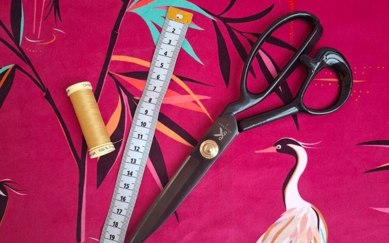Sewing accessories placed on a bright piece of fabric.