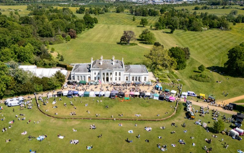An aerial view of Hylands House with a market out front.