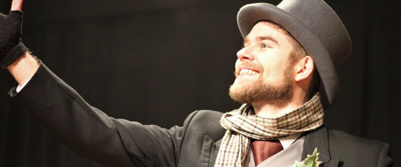 A man preforming on stage. 