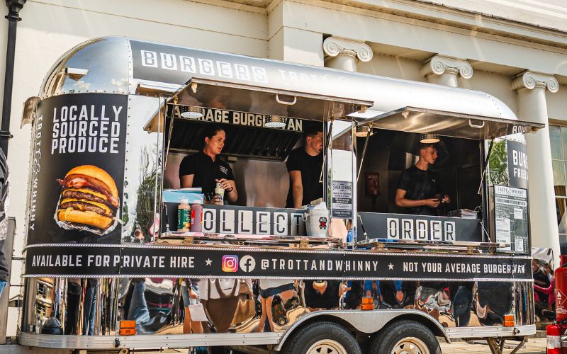 trot and whinny Food truck selling hamburgers.