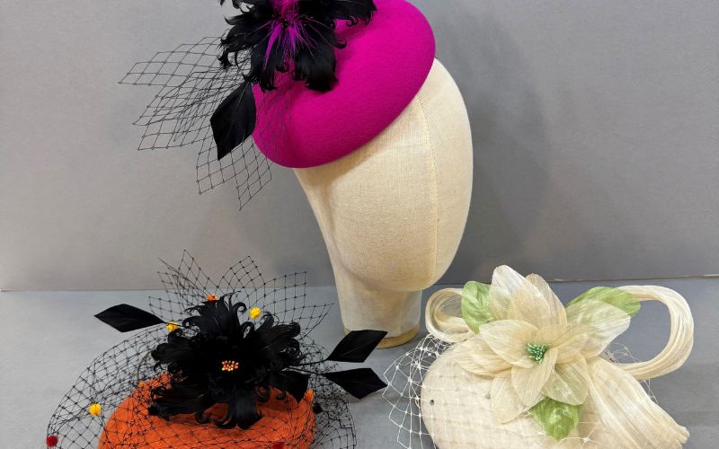 Three colourful hats on display.